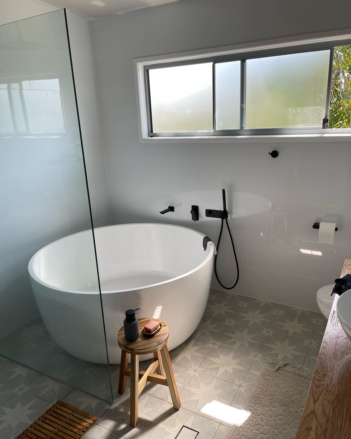 Freestanding Tub: Freestanding bath with a wall-mounted filler and full-height tiling.